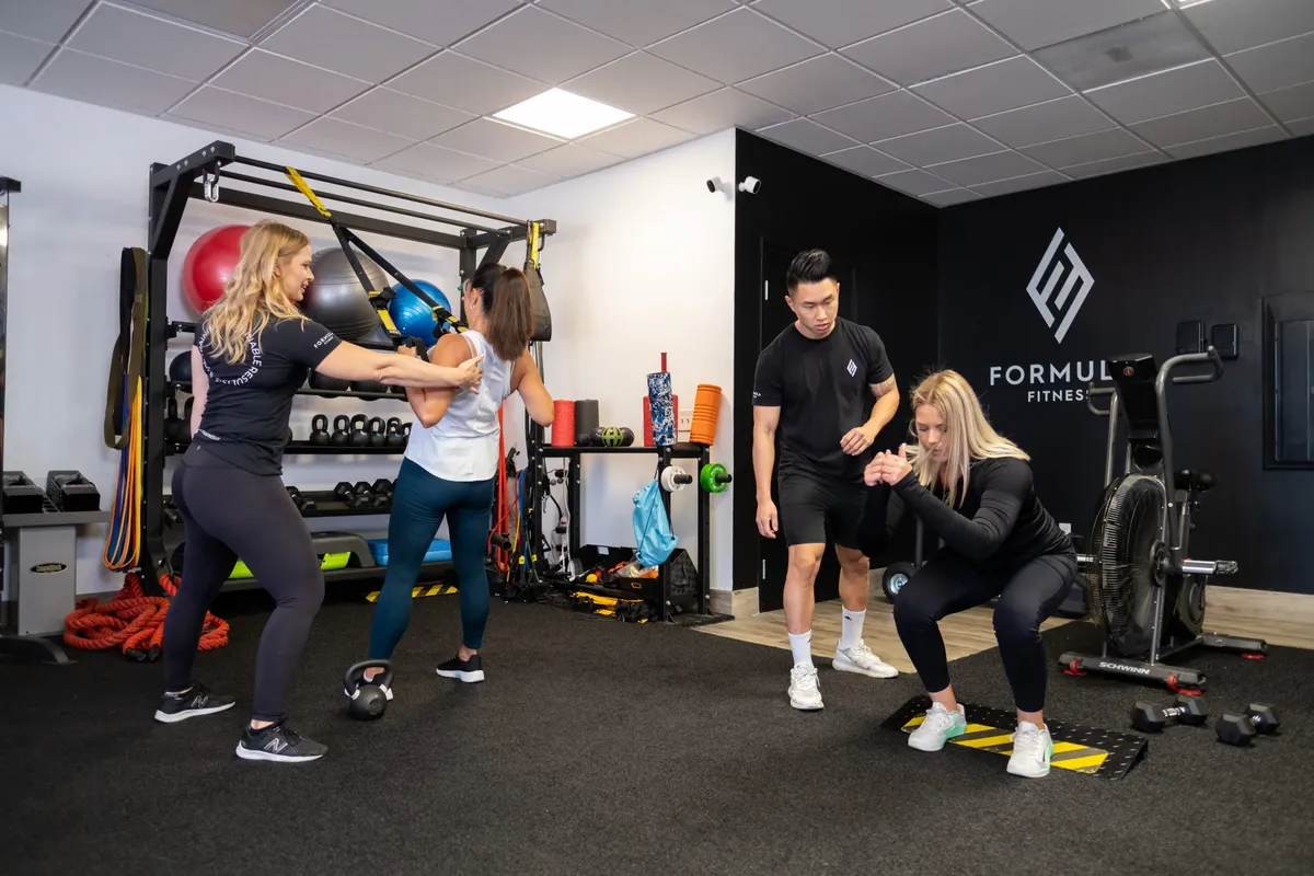 Coaches working with clients in the Formula Fitness studio